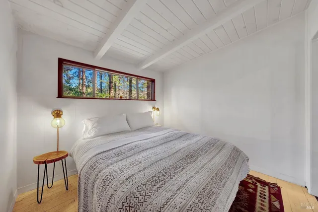 a bedroom with a bed and a view of kitchen