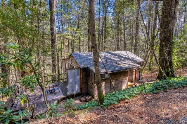 a view of a house with a yard and sitting area