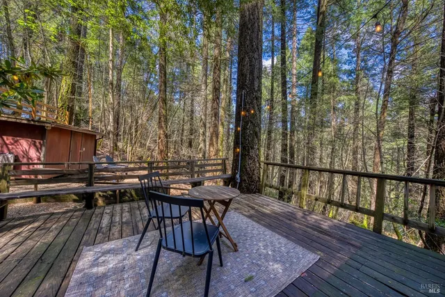 a view of a patio with table and chairs and wooden floor