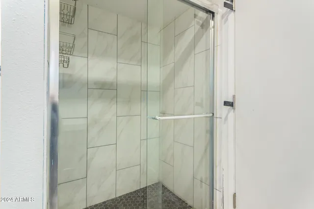 a bathroom with a glass shower door
