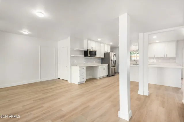 a view of a kitchen with a sink and a refrigerator