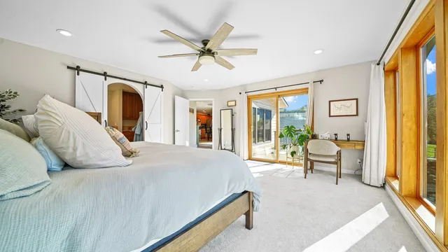 a bedroom with a large bed and a chandelier