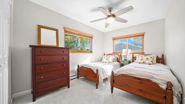 a bedroom with two beds and a window