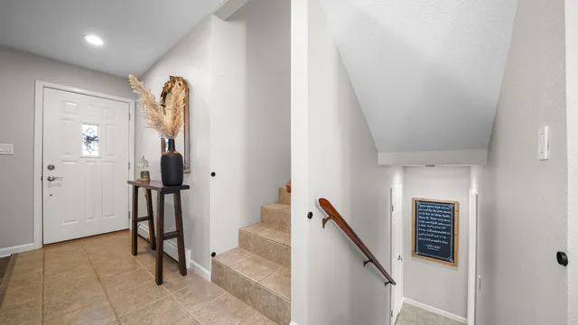 a view of a hallway with entryway and hall with wooden floor