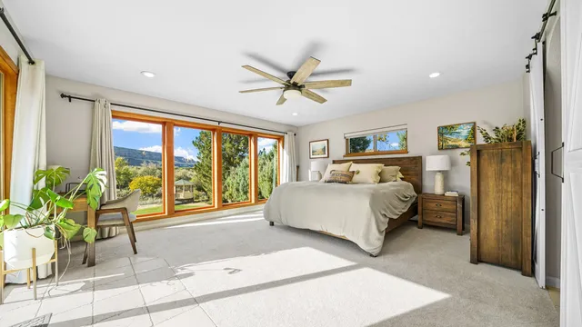 a spacious bedroom with a bed and a large window