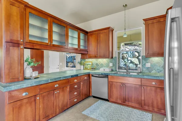 a kitchen with stainless steel appliances granite countertop a refrigerator and a sink