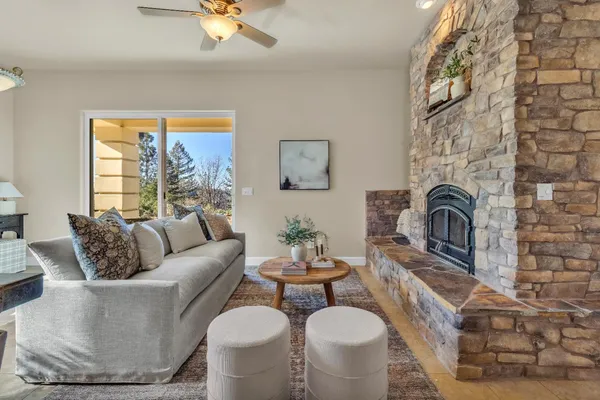 a living room with furniture a fireplace and a table