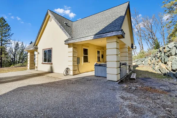 a bathroom with a granite countertop sink a mirror and shower
