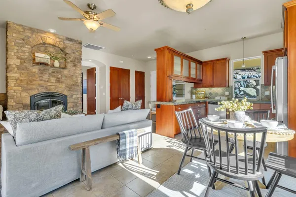a living room with fireplace furniture and a chandelier