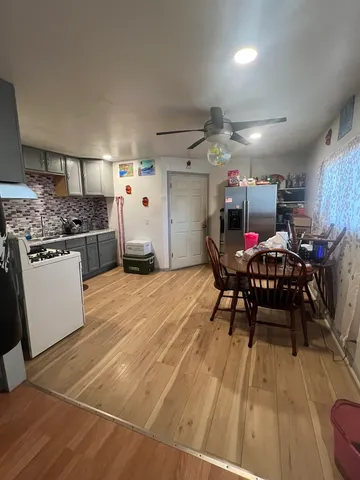 a kitchen with stainless steel appliances granite countertop a stove and a refrigerator