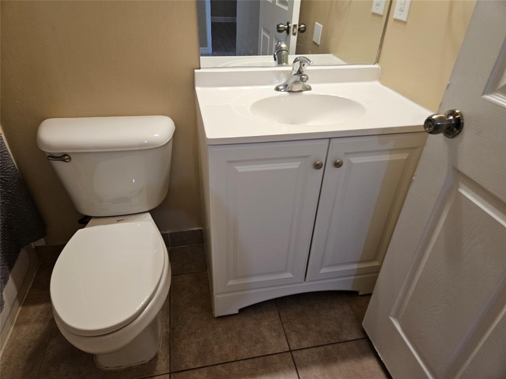 9082 Plymouth Place, Unit 9082 Tamarac, FL 33321 - Photo 11 of 47 a bathroom with a toilet sink and mirror
