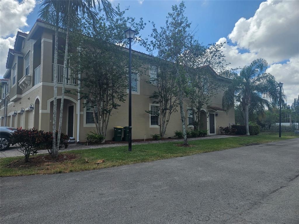 9082 Plymouth Place, Unit 9082 Tamarac, FL 33321 - Photo 16 of 47 a view of a road with a building in the background