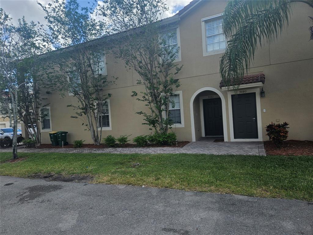 9082 Plymouth Place, Unit 9082 Tamarac, FL 33321 - Photo 18 of 47 a front view of a house with a garden