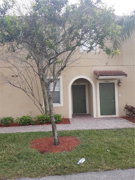 9082 Plymouth Place, Unit 9082 Tamarac, FL 33321 - Photo 19 of 47 a front view of a house with garden