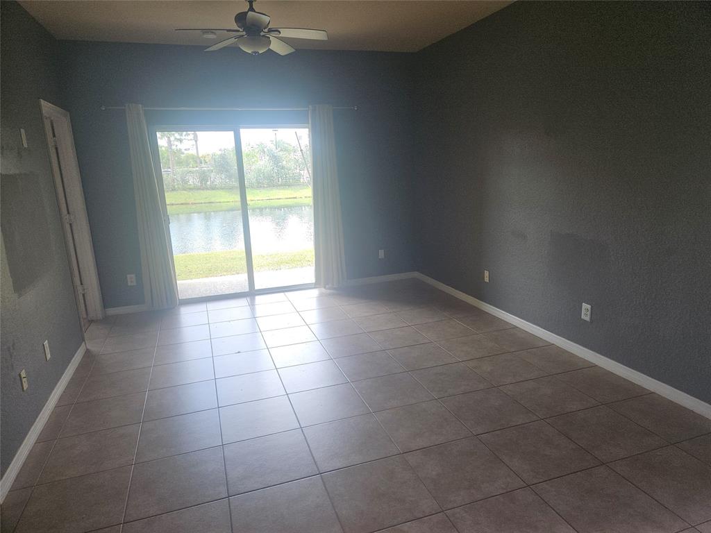 9082 Plymouth Place, Unit 9082 Tamarac, FL 33321 - Photo 21 of 47 a view of an empty room with a window
