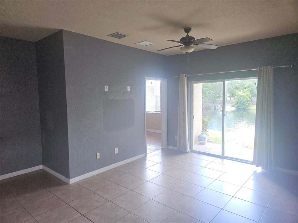 9082 Plymouth Place, Unit 9082 Tamarac, FL 33321 - Photo 22 of 47 a view of a livingroom with a ceiling fan and window