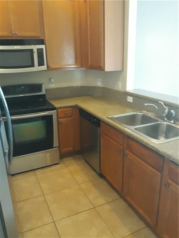 9082 Plymouth Place, Unit 9082 Tamarac, FL 33321 - Photo 23 of 47 a kitchen with a sink and cabinets