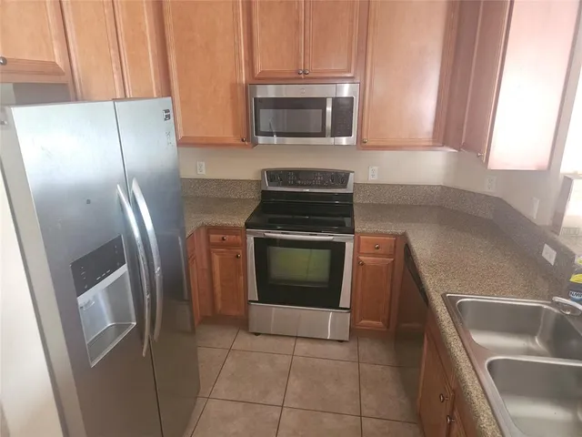 a kitchen with a stove microwave and refrigerator