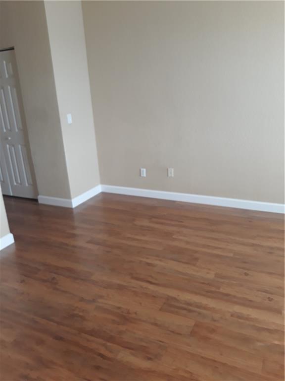 9082 Plymouth Place, Unit 9082 Tamarac, FL 33321 - Photo 28 of 47 a view of an empty room with wooden floor