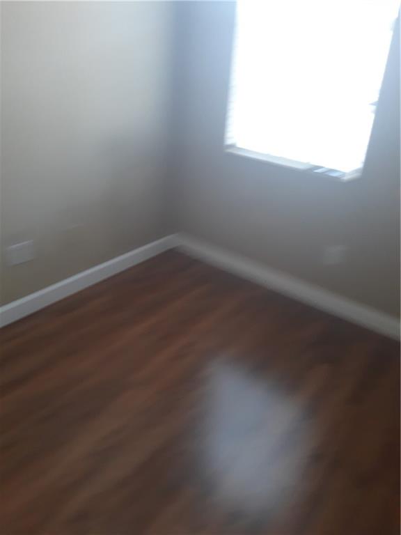 9082 Plymouth Place, Unit 9082 Tamarac, FL 33321 - Photo 29 of 47 an empty room with wooden floor and windows