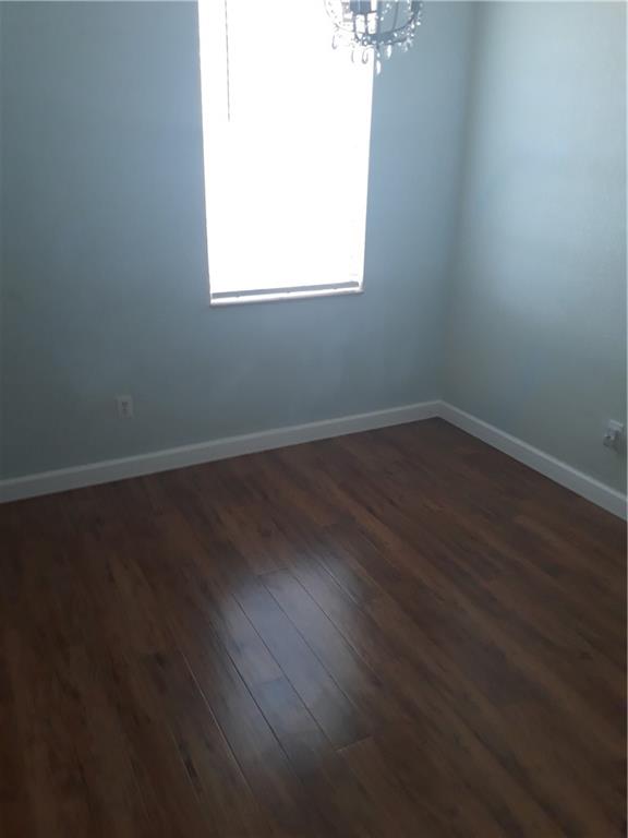 9082 Plymouth Place, Unit 9082 Tamarac, FL 33321 - Photo 30 of 47 an empty room with wooden floor and windows