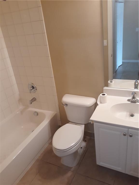 9082 Plymouth Place, Unit 9082 Tamarac, FL 33321 - Photo 32 of 47 a white toilet sitting next to a bathroom sink and vanity