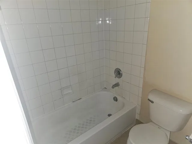 a bathroom with a bathtub and a toilet