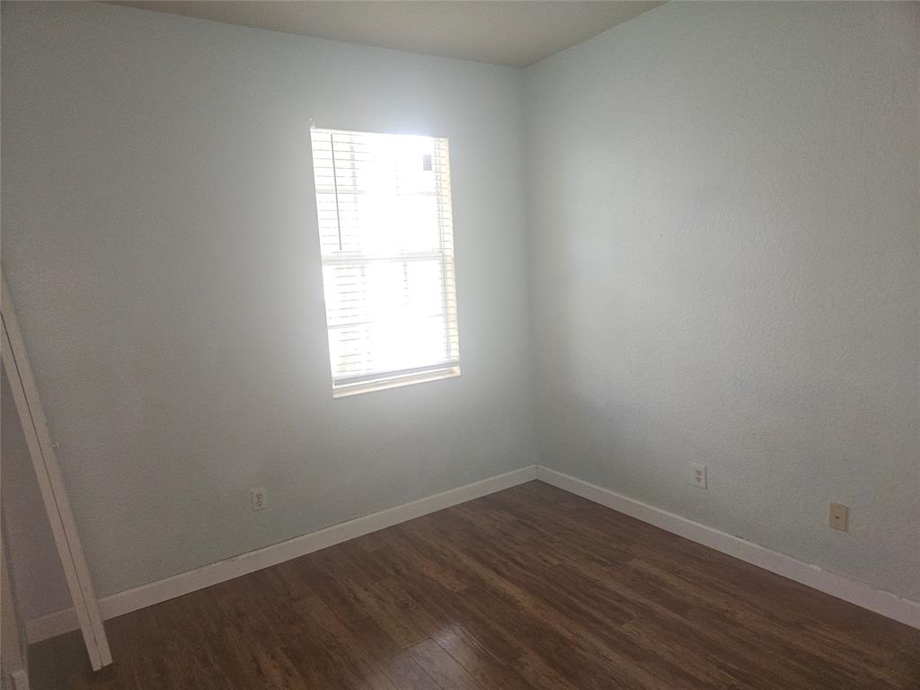 9082 Plymouth Place, Unit 9082 Tamarac, FL 33321 - Photo 39 of 47 an empty room with wooden floor and window