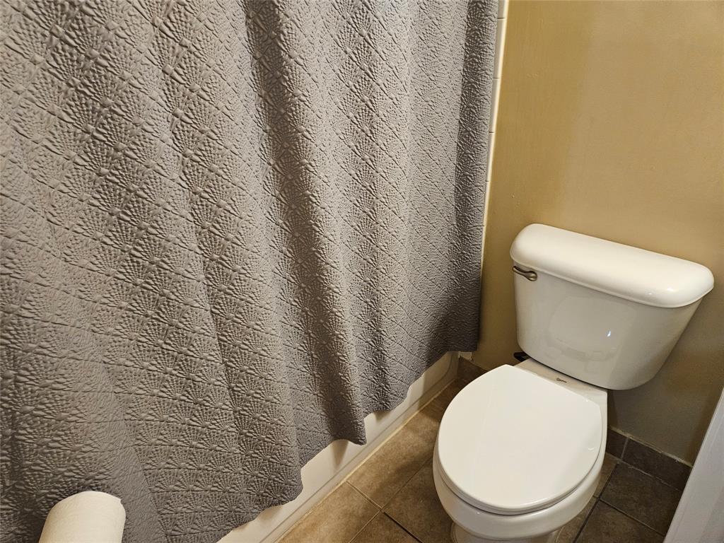 9082 Plymouth Place, Unit 9082 Tamarac, FL 33321 - Photo 45 of 47 a white toilet sitting next to a white wall