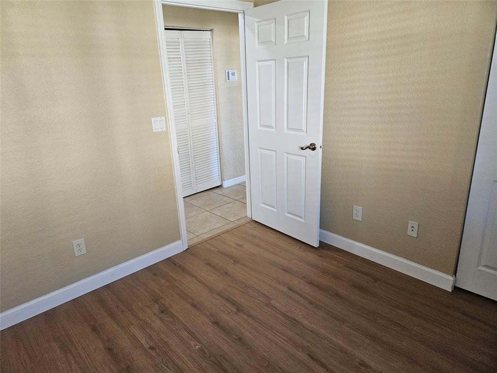 9082 Plymouth Place, Unit 9082 Tamarac, FL 33321 - Photo 46 of 47 a view of an empty room with wooden floor