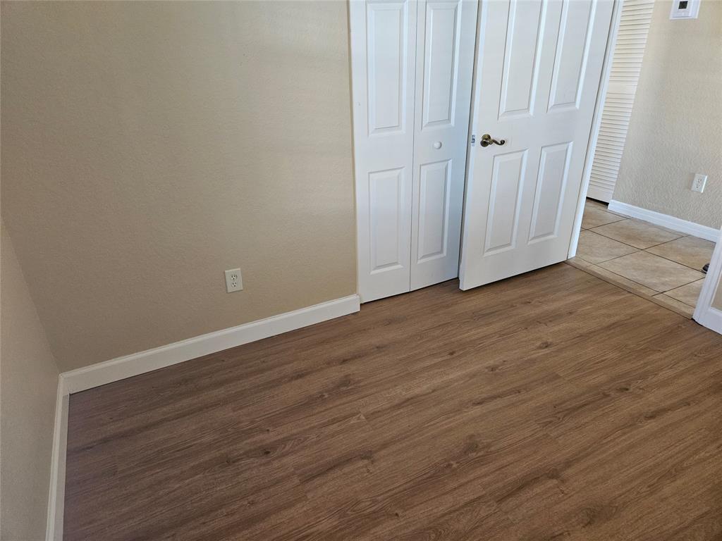 9082 Plymouth Place, Unit 9082 Tamarac, FL 33321 - Photo 47 of 47 a view of an empty room with wooden floor