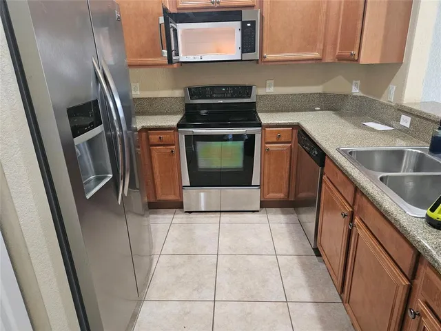 a kitchen with a sink a stove and cabinets