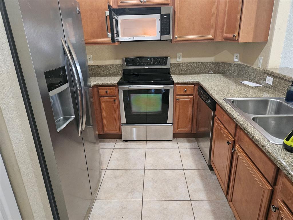 9082 Plymouth Place, Unit 9082 Tamarac, FL 33321 - Photo 7 of 47 a kitchen with a sink a stove and cabinets