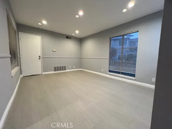 an empty room with windows and closet