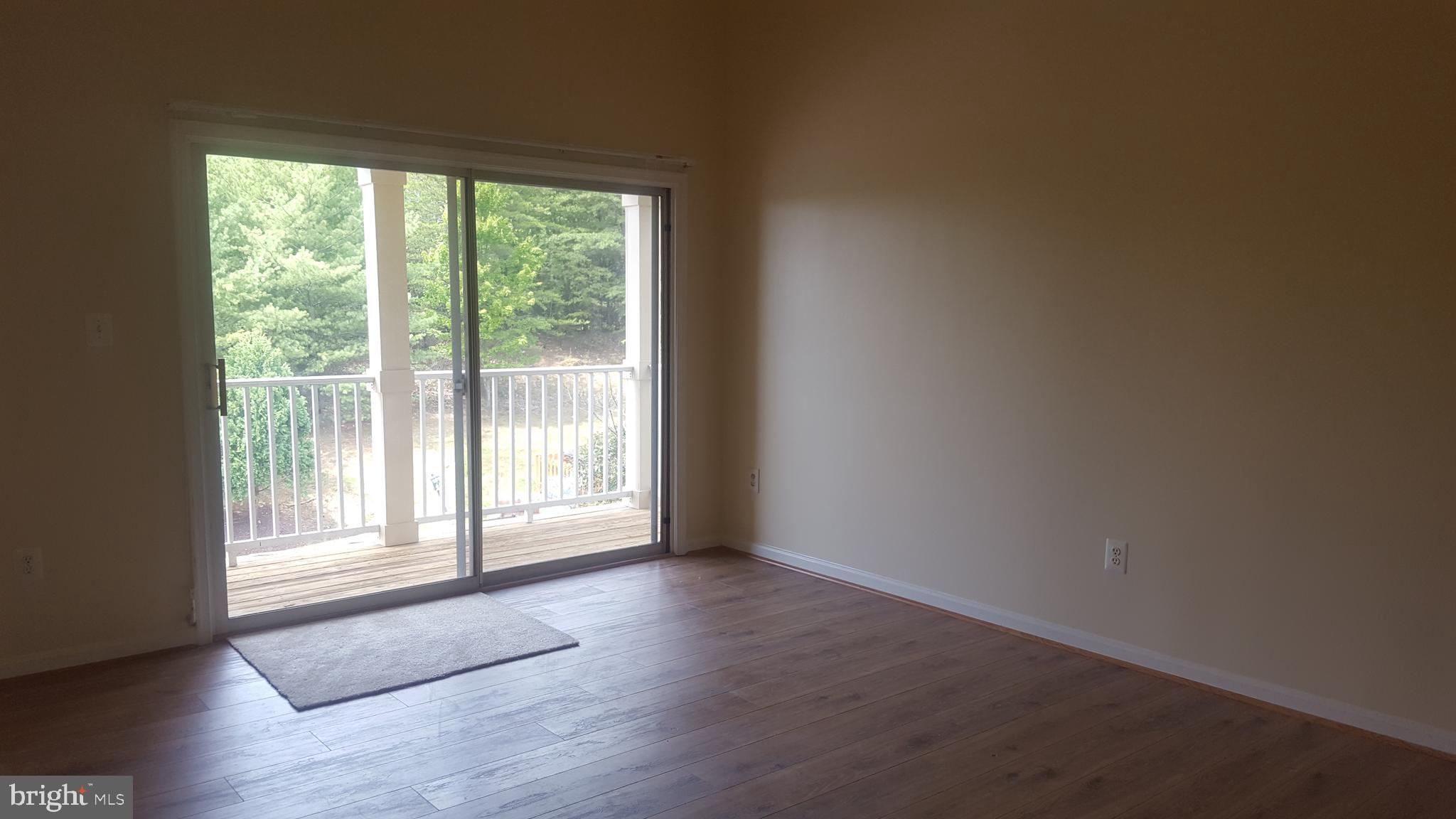 1049 Gardenview Loop, Unit 401 Woodbridge, VA 22191 - Photo 9 of 18 Living room with sliding door to balcony