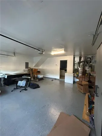 an empty room with windows and chandelier fan