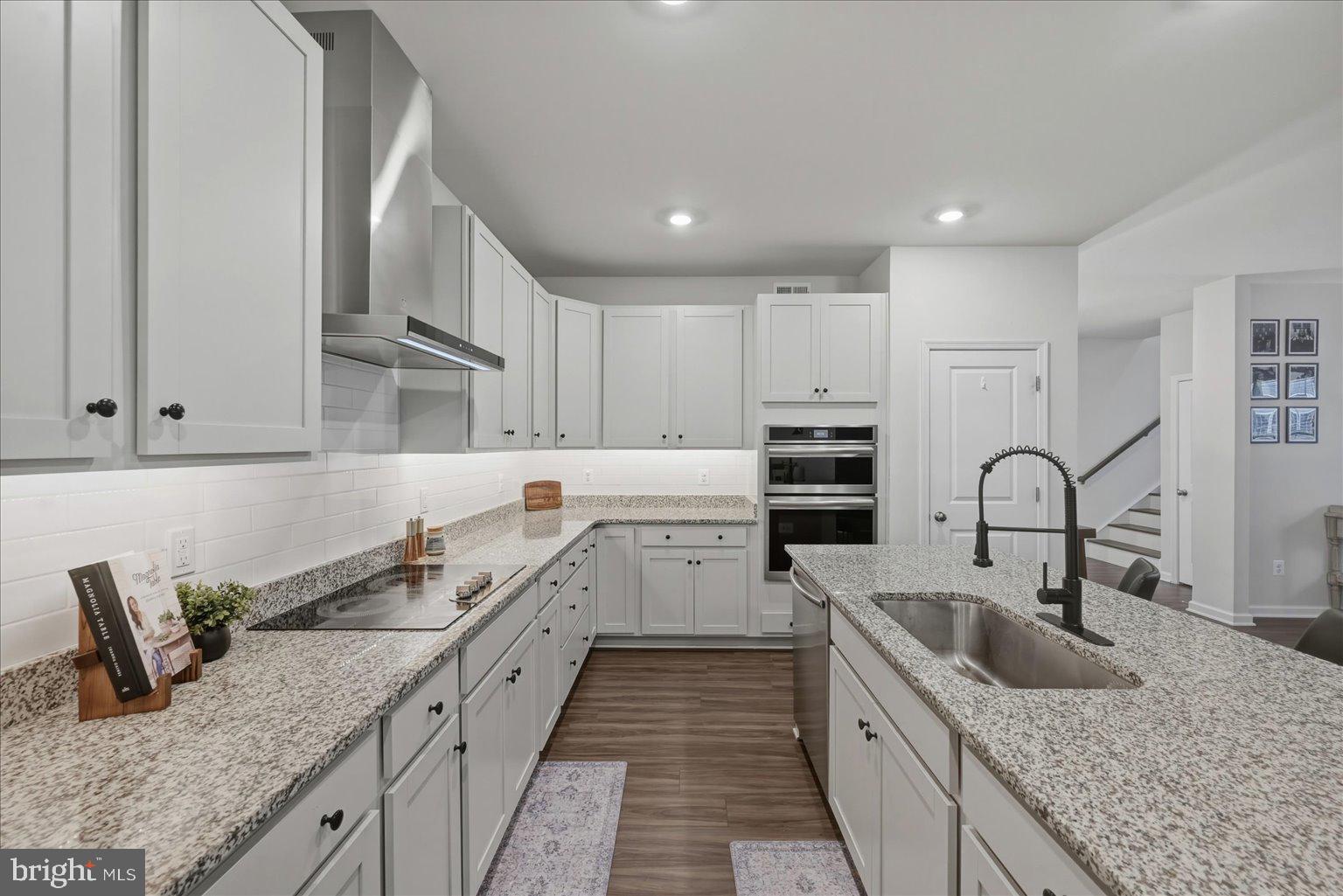 1311 Foal Street Ranson, WV 25438 - Photo 13 of 38 a kitchen with stainless steel appliances granite countertop a sink stove refrigerator and cabinets