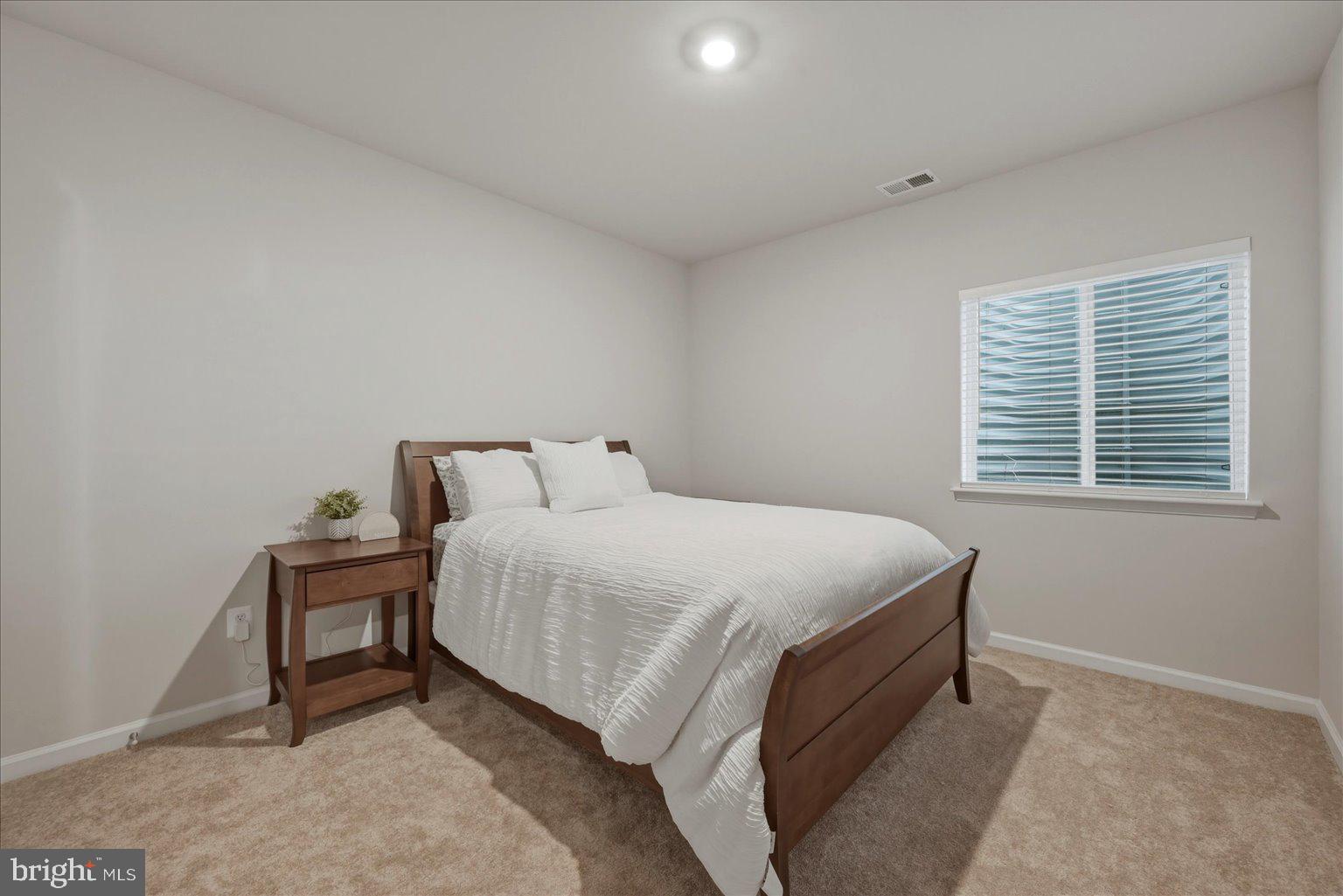 1311 Foal Street Ranson, WV 25438 - Photo 30 of 38 a bed sitting in a bedroom next to a window