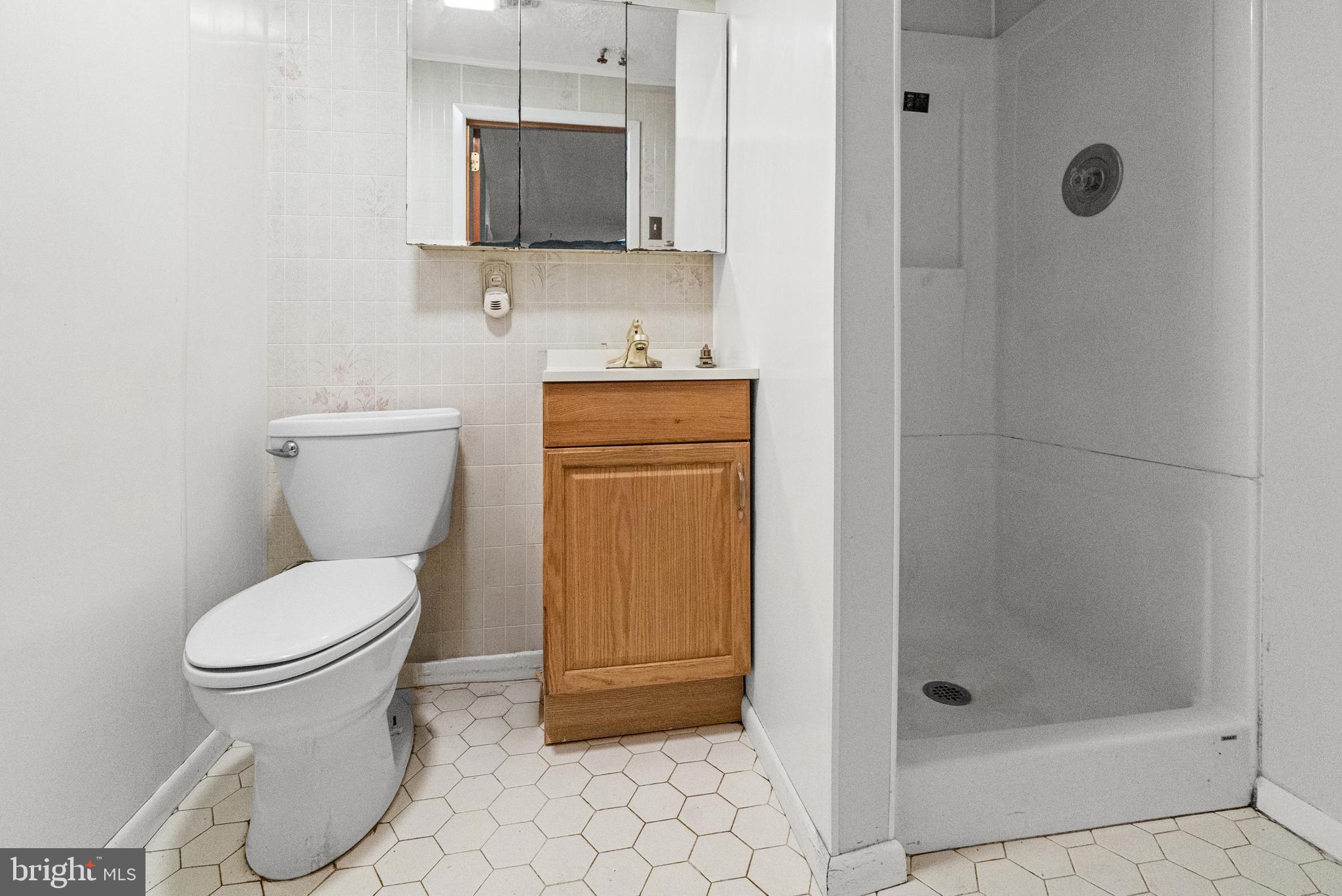 8806 Ashford Road Baltimore, MD 21234 - Photo 18 of 23 a bathroom with a toilet and a sink