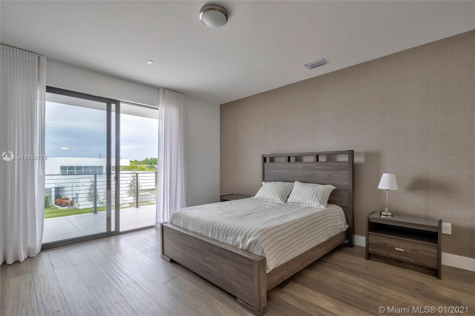 16610 Sunset Way Weston, FL 33326 - Photo 13 of 55 a bedroom with a bed and a night stand