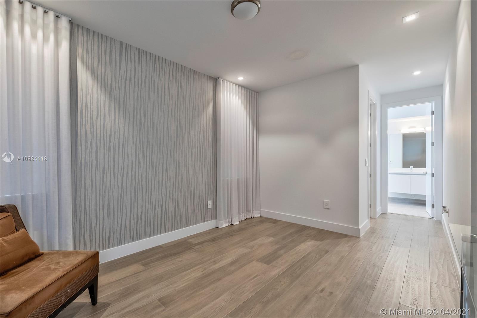 16610 Sunset Way Weston, FL 33326 - Photo 18 of 55 an empty room with wooden floor and windows