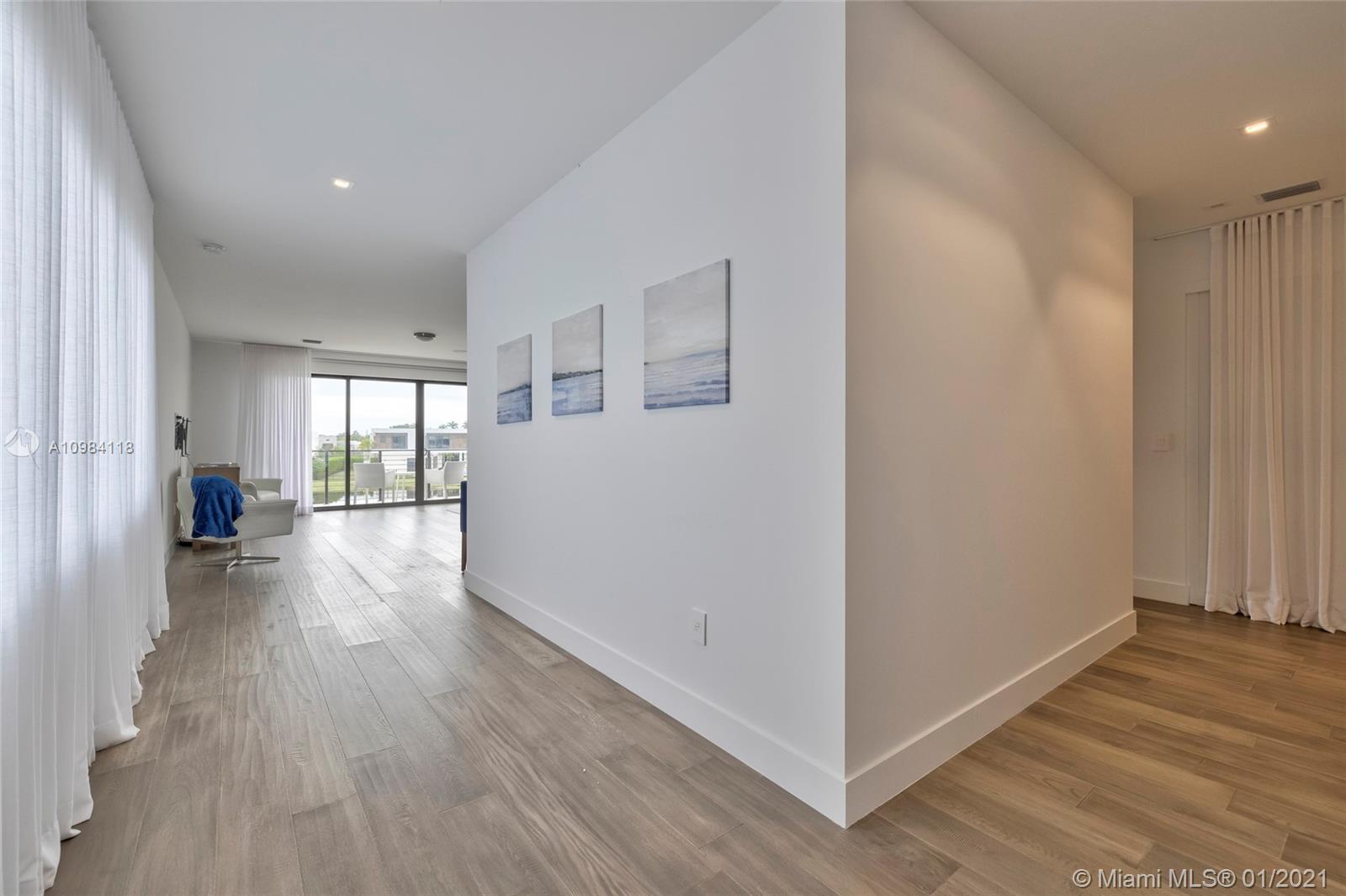 16610 Sunset Way Weston, FL 33326 - Photo 20 of 55 a view of a hallway with wooden floor and cabinet