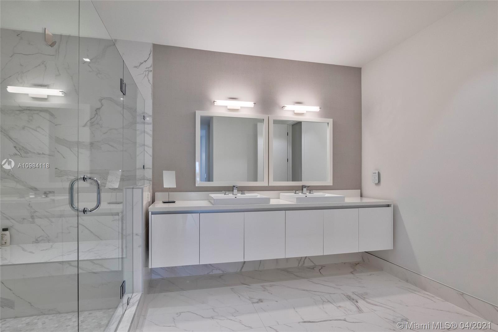 16610 Sunset Way Weston, FL 33326 - Photo 23 of 55 a large bathroom with a double vanity sink and a mirror