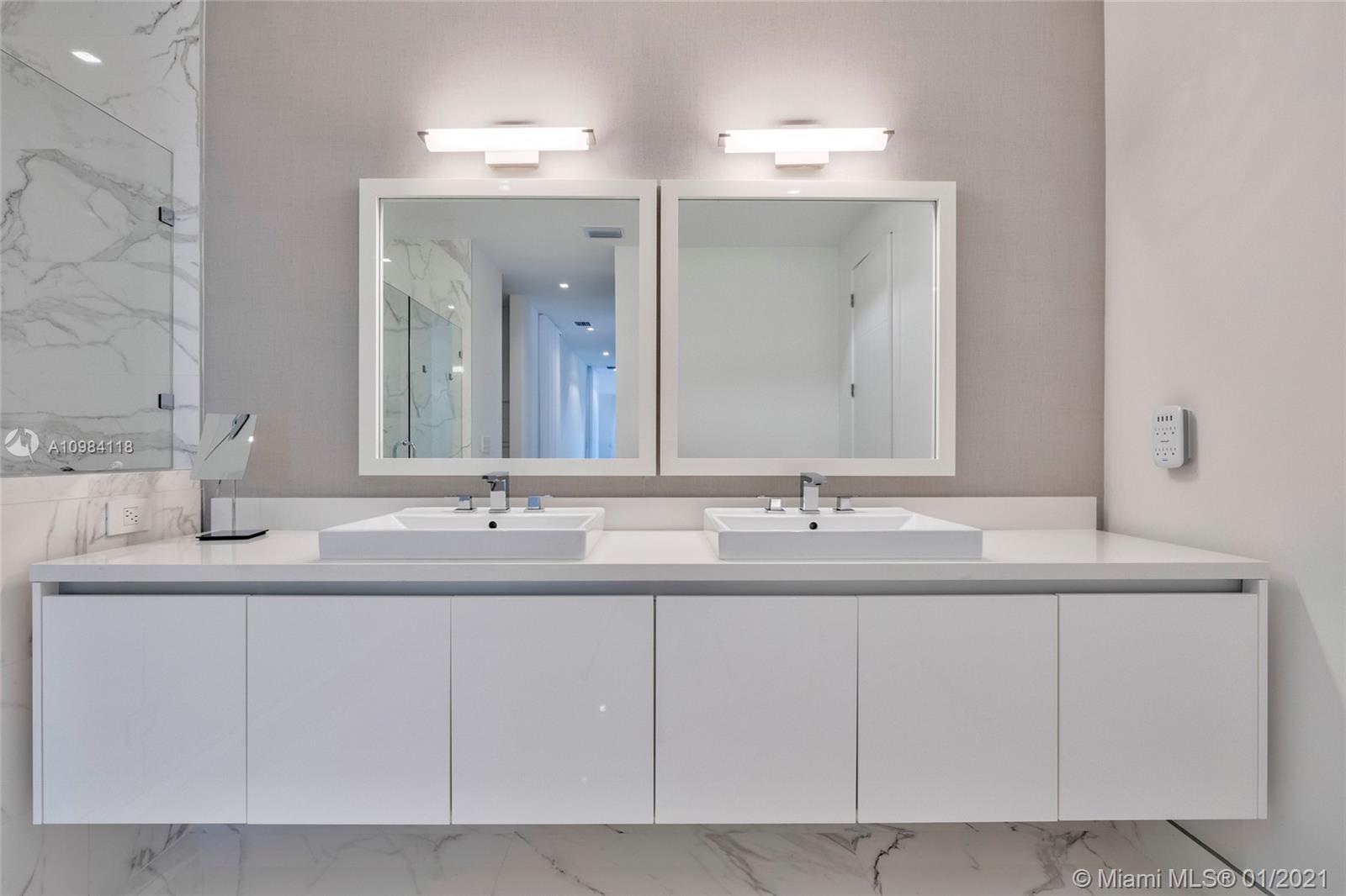 16610 Sunset Way Weston, FL 33326 - Photo 25 of 55 a bathroom with a sink and a mirror