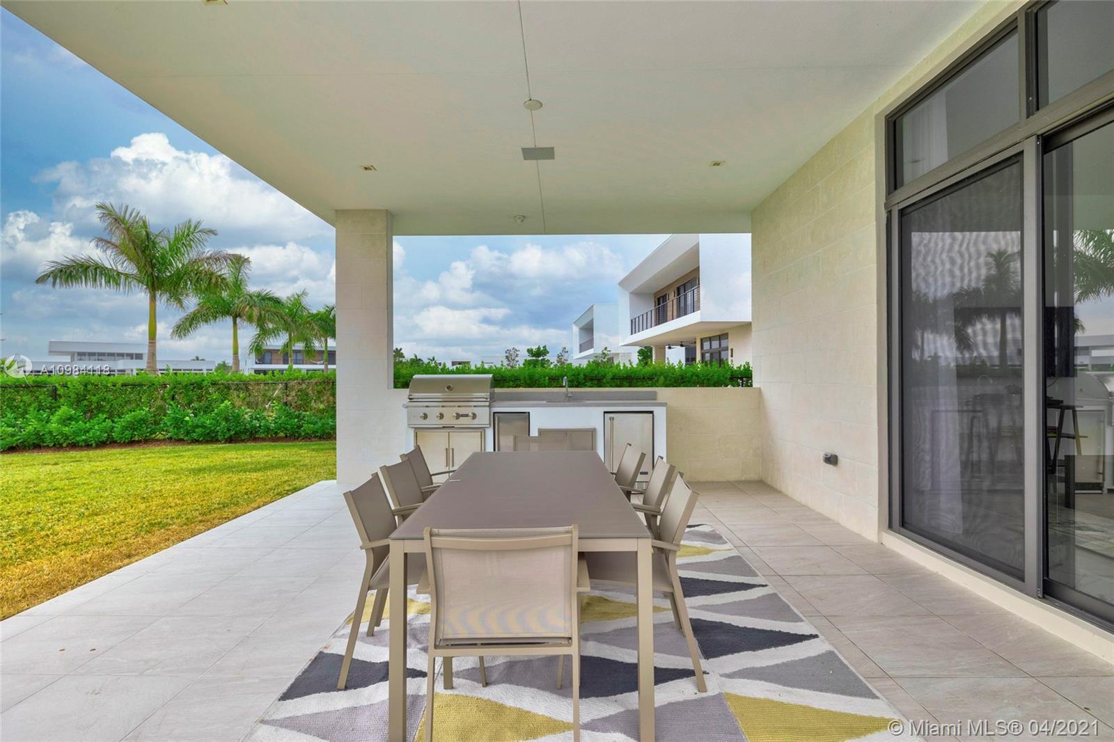 16610 Sunset Way Weston, FL 33326 - Photo 29 of 55 a view of a patio with table and chairs and potted plants