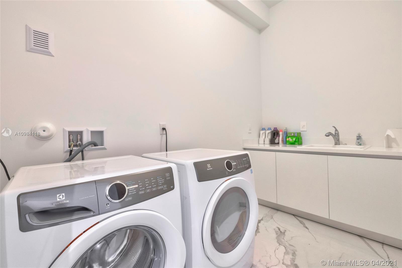 16610 Sunset Way Weston, FL 33326 - Photo 30 of 55 a utility room with dryer and washer