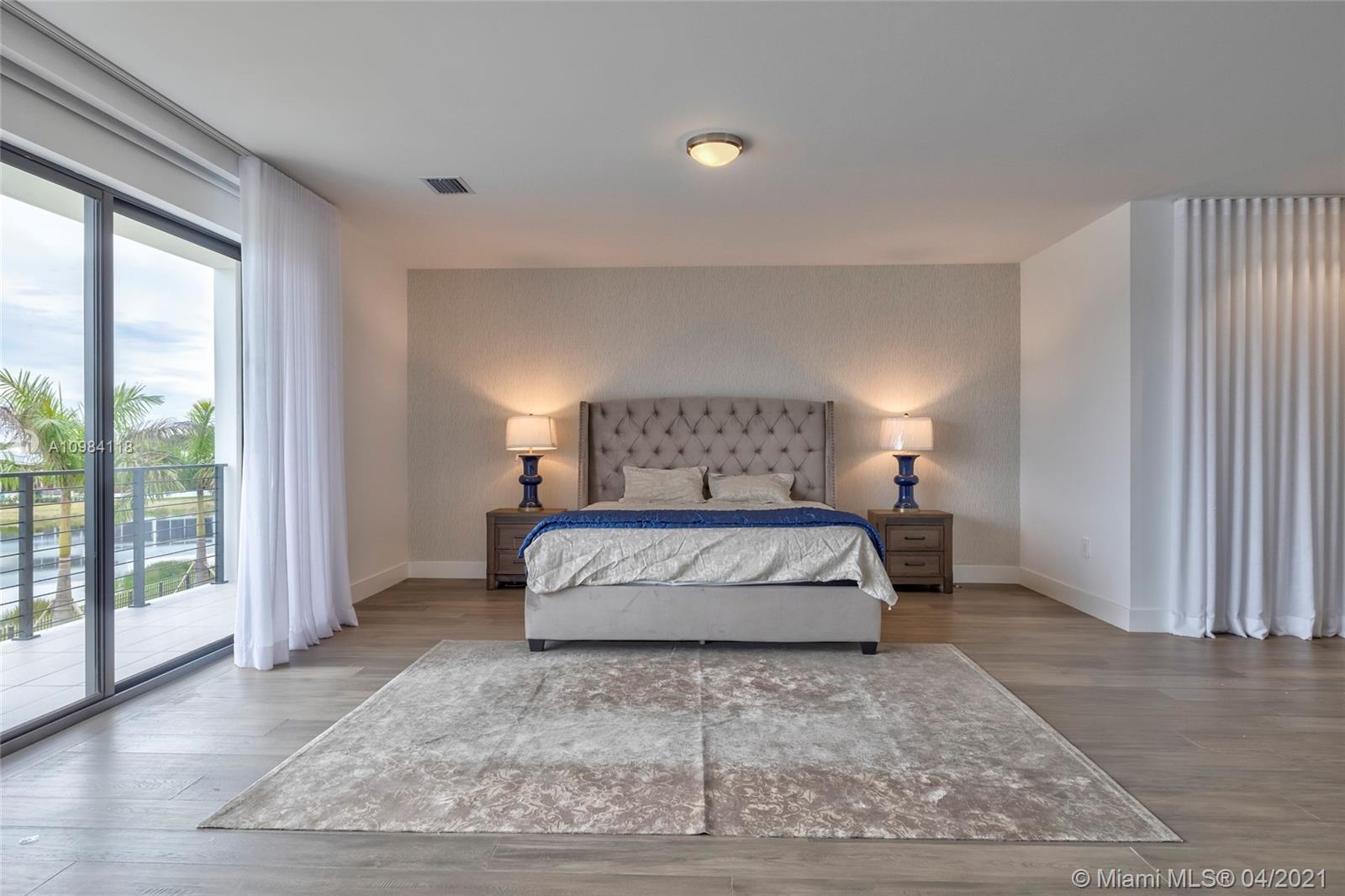 16610 Sunset Way Weston, FL 33326 - Photo 42 of 55 a bedroom with a large bed and a large window