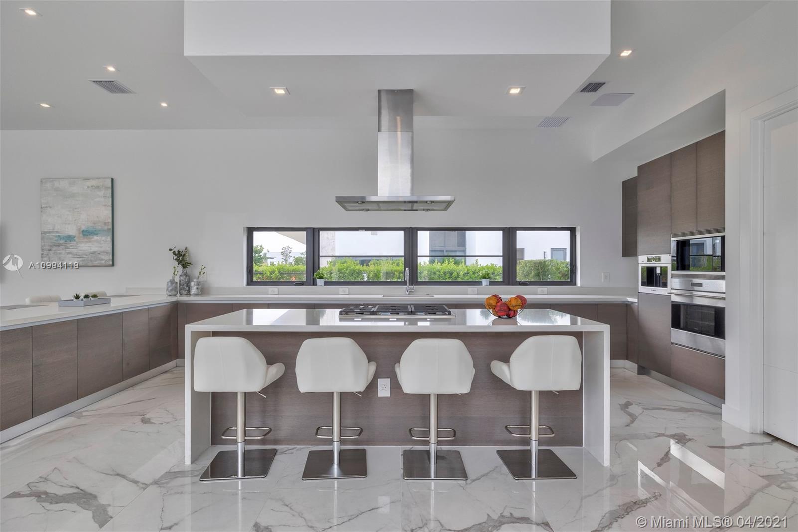 16610 Sunset Way Weston, FL 33326 - Photo 48 of 55 a kitchen with a sink and chairs