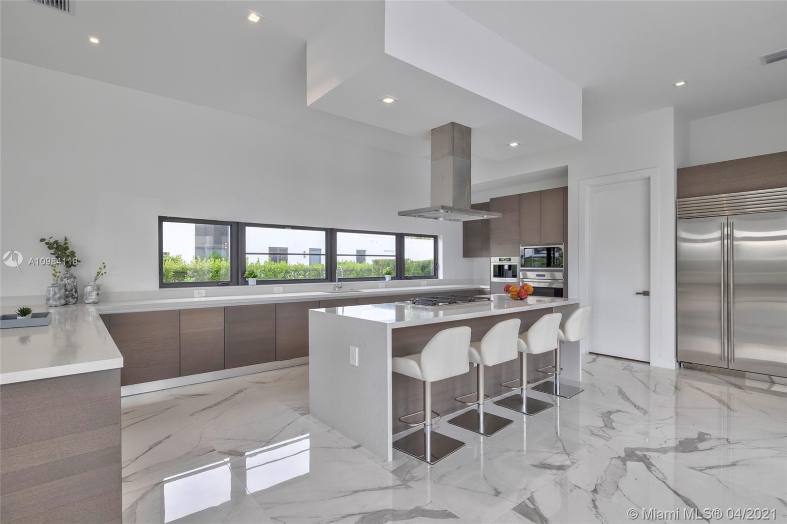 16610 Sunset Way Weston, FL 33326 - Photo 51 of 55 a kitchen with stainless steel appliances kitchen island granite countertop a table chairs sink and cabinets