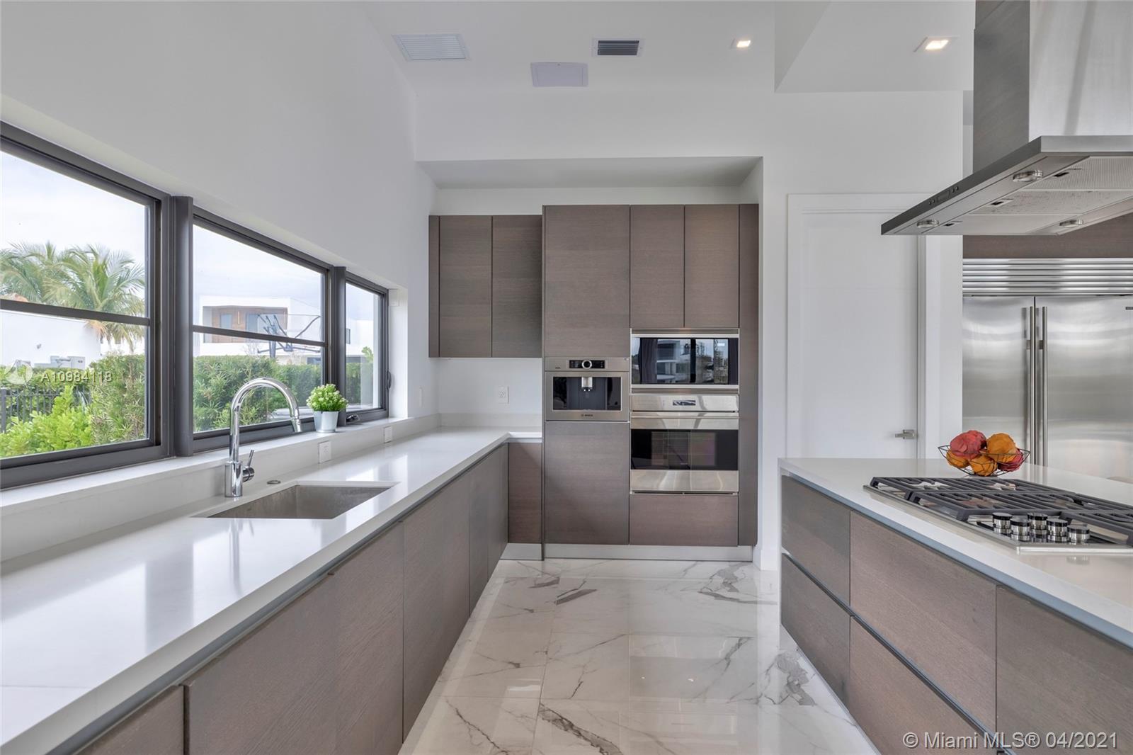 16610 Sunset Way Weston, FL 33326 - Photo 53 of 55 a large kitchen with stainless steel appliances a large window and a counter space